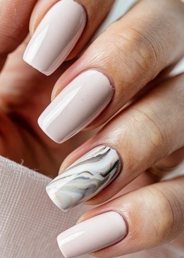 Elegant pastel pink manicure with marble nail art design and well-groomed cuticles.