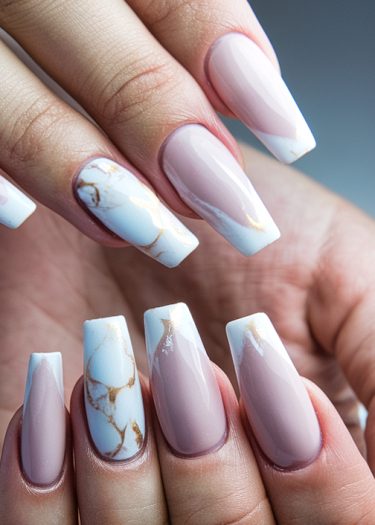 Elegant pastel pink coffin nails with gold accents and marble art design.