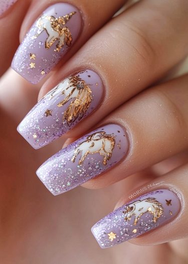 Pastel purple unicorn nails with glitter and gold accents create a whimsical, enchanting manicure.