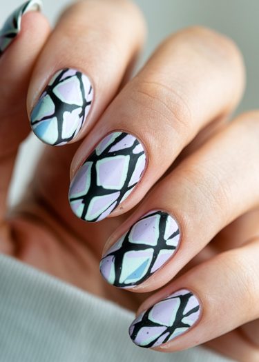 Elegant pastel stained glass nail art with bold geometric designs and almond shapes.