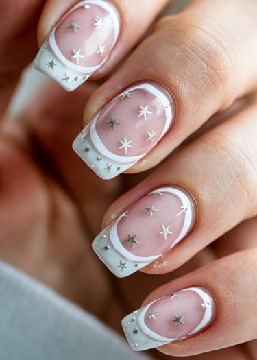 Elegant pastel star nail art with crescent shapes on a glossy pink base.