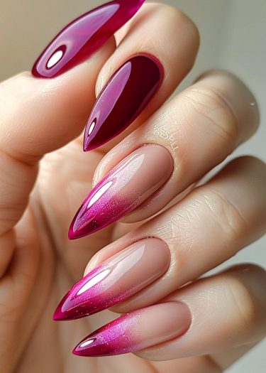 Stylish stiletto nails featuring vibrant berry tones and dazzling glitter for elegant nail art.