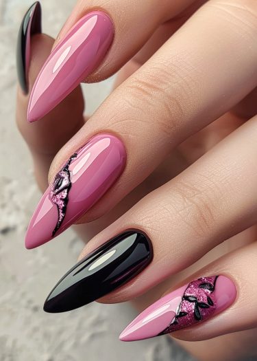 Stunning pink and black almond-shaped nails with glittery designs and high-gloss finish.