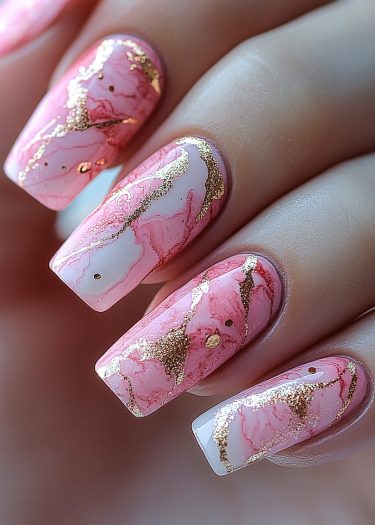 Elegant pink marble nail design with golden accents for a luxurious, sophisticated look.