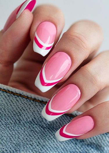 Elegant pink striped nail art with glossy finish against denim background.