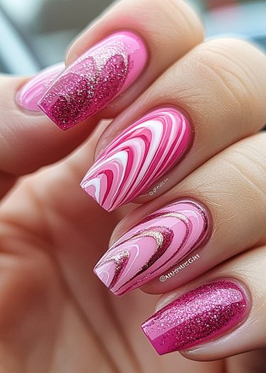 Elegant pink and white glitter nail art design featuring intricate marbling and shimmering details.