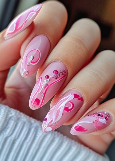 Elegant pink and white marble nail art with glitter and rhinestones for a stunning manicure.