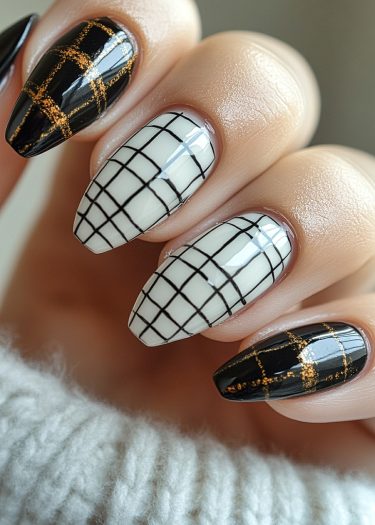 Elegant geometric nail art in black, white, and gold with a modern plaid design.