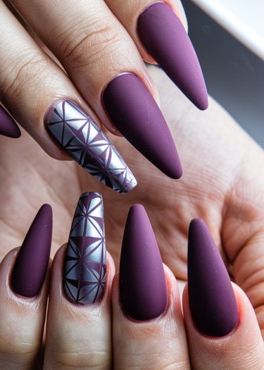 Elegant plum stiletto nails with geometric silver accents for a chic nail art design.