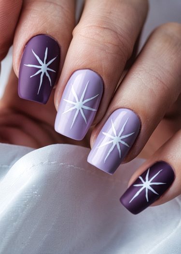 Artistic plum and lavender nail art featuring intricate star patterns for a sophisticated look.