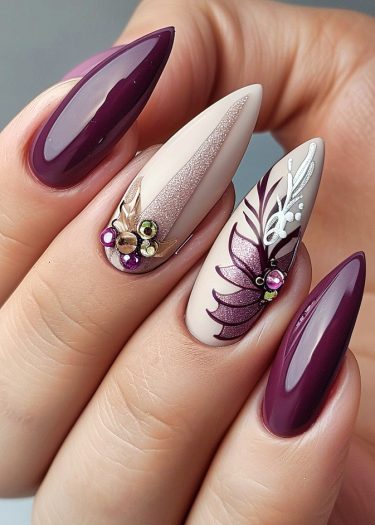 Elegant plum and nude stiletto nail art with metallic pink accents and decorative elements.