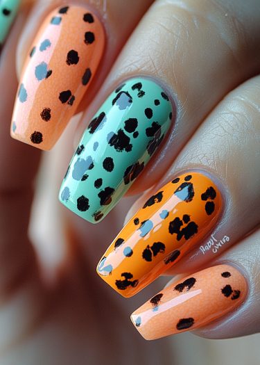 Vibrant orange and mint green leopard print nail art in glossy finish.