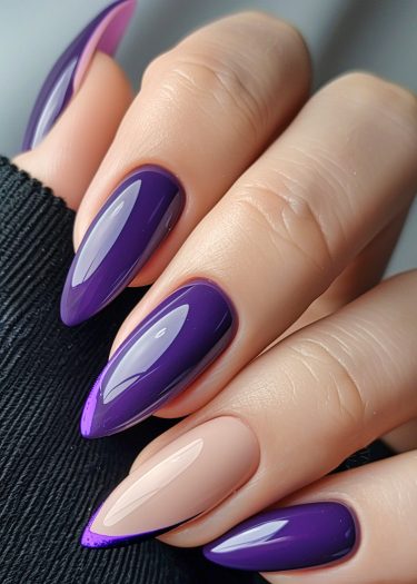 Elegant almond-shaped nails in glossy purple and nude shades, showcasing modern nail art design.