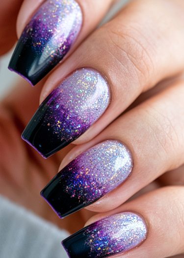 Elegant purple-black gradient nails with glitter for a chic, stylish manicure.