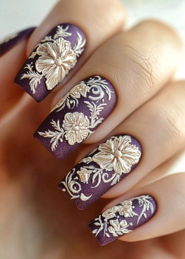 Exquisite purple floral nail art with metallic gold designs and intricate details for elegant style.