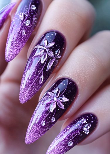 Elegant purple glitter nail art with floral designs and stiletto shapes for a sophisticated look.