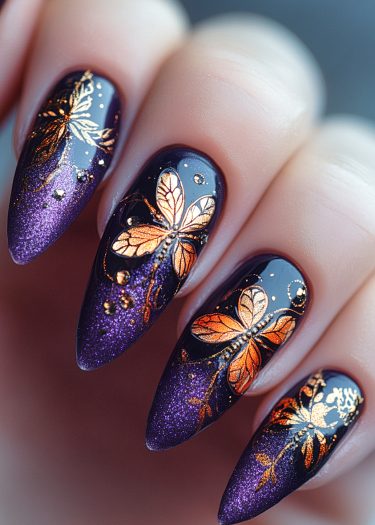 Elegant purple and gold butterfly nail art with shimmering accents on almond-shaped nails.