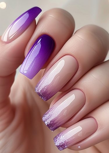 Elegant purple gradient nail art with glossy finish and sparkling ombré design.