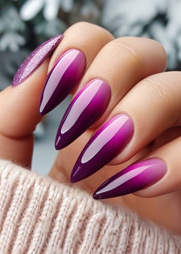 Stunning stiletto nails with a purple-to-pink gradient and glittery designs for elegant manicures.