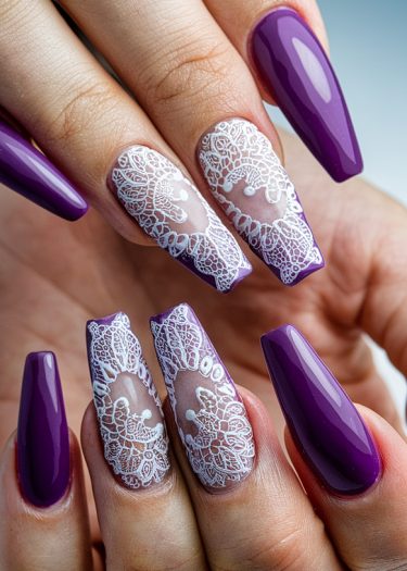 Elegant purple lace nail art featuring almond-shaped nails with intricate designs.