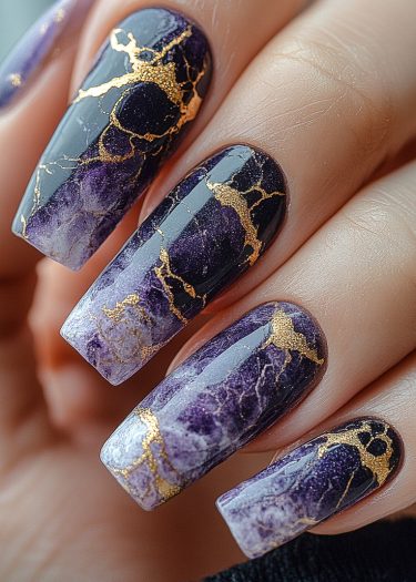 Elegant purple marble nail art with gold accents for a luxurious, sophisticated manicure.