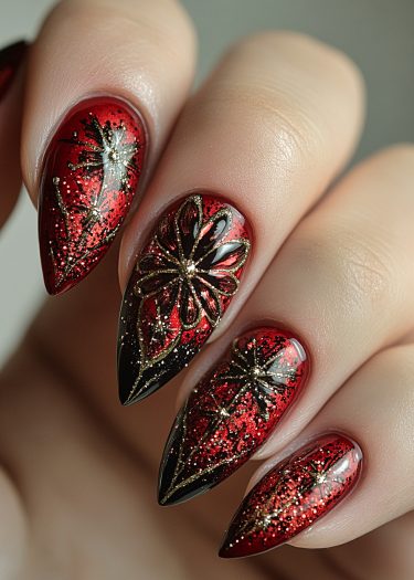 Elegant red and gold stiletto nail art with black accents and glittery details.