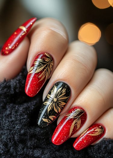 Elegant red, black, and gold nail art with intricate designs and shimmering details.