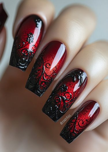 Stunning red-black ombre nail art with intricate black designs for a bold, elegant look.