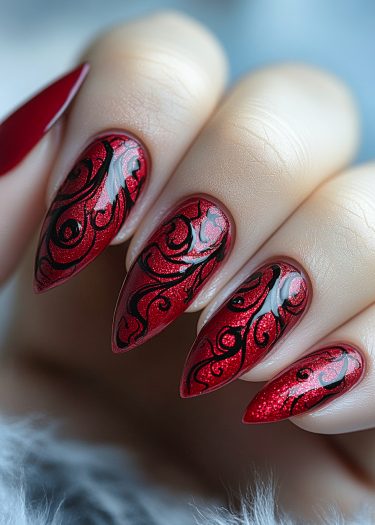 Elegant red glitter nail art with intricate black swirls on almond-shaped nails.