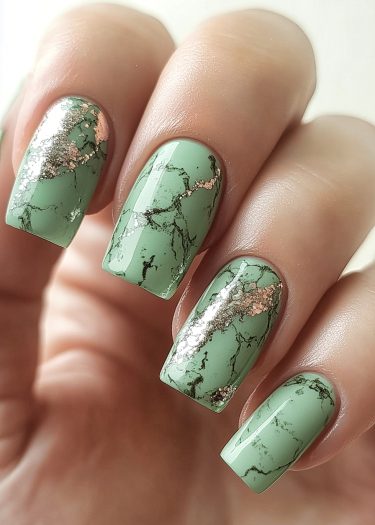 Elegant sage green marble nails with gold accents for a chic and sophisticated look.