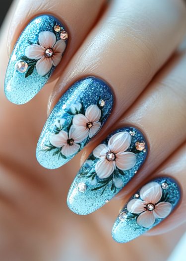 Exquisite blue glittery floral nail art with rhinestones for elegant, sophisticated elegance.