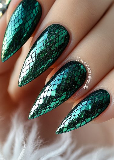 Stunning emerald green stiletto nails with intricate reptilian scale design and luxurious shine.