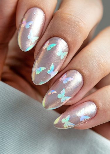 Elegant almond-shaped nails with iridescent pink finish and whimsical butterfly decals.