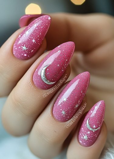 Elegant manicure featuring shimmering pink nails with celestial moon and star designs.