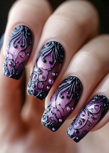 Elegant purple and pink gradient nail art with intricate black designs and sparkling rhinestones.