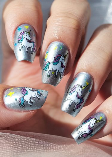 Enchanting unicorn nail art on shimmering silver backdrop with colorful stars and golden accents.