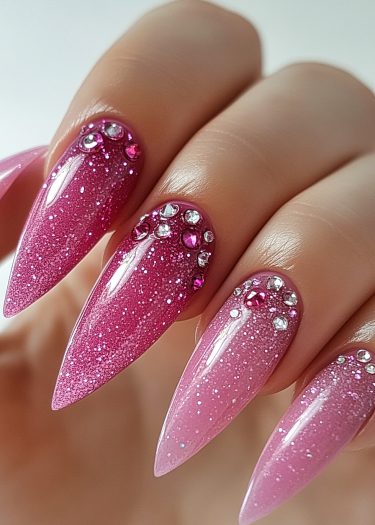 Glamorous pink glitter nails with rhinestones, perfect for a luxurious manicure look.