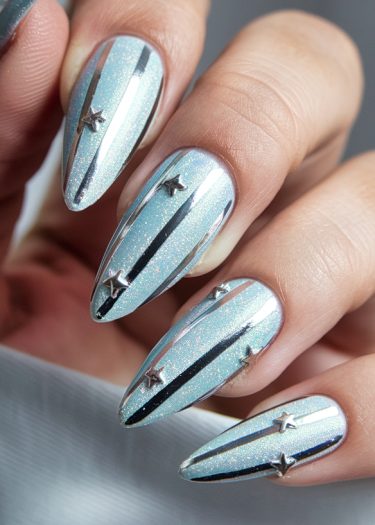 Stunning silver-blue almond-shaped nails with chrome stripes and celestial star embellishments.