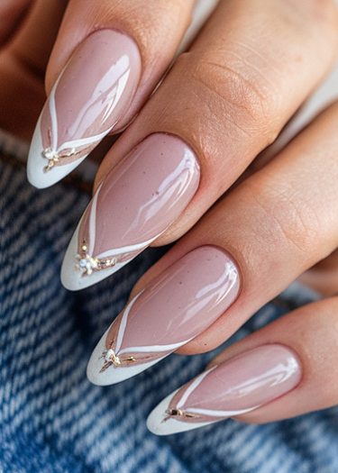 Elegant almond-shaped nails with soft pink base and modern French tip design.