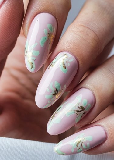 Elegant soft pink floral nail art with mint green and gold accents for a chic look.