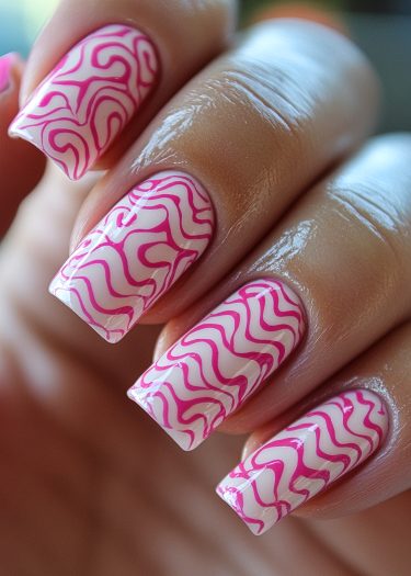 Stylish soft white nails with vibrant pink wavy designs for elegant nail art inspiration.