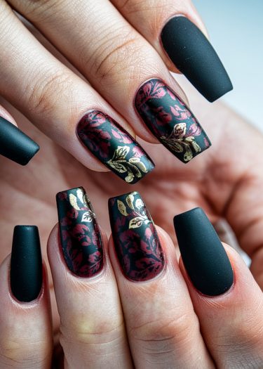 Sophisticated black matte nails with red roses and golden leaves for elegant nail art inspiration.