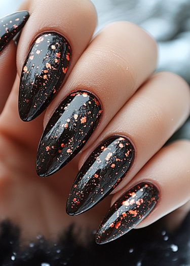 Elegant black almond nails with vibrant glitter for a chic nail art design.