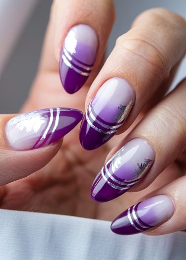 Elegant purple ombre nails with silver accents and palm tree designs in a sophisticated manicure.