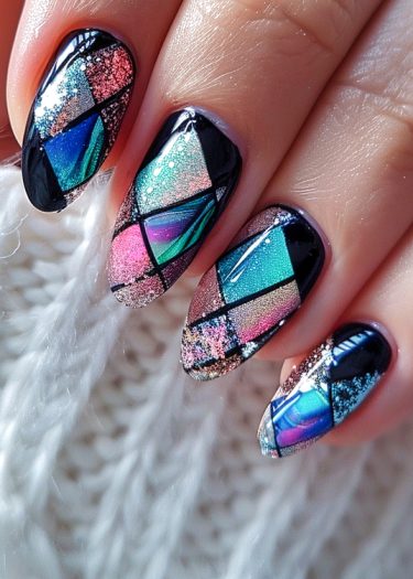 Vibrant stained glass manicure featuring intricate geometric patterns and a glossy, shimmering finish.