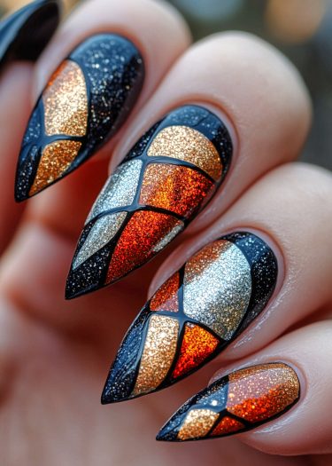 Stained glass nail art featuring glittery geometric designs in gold, silver, and red hues.