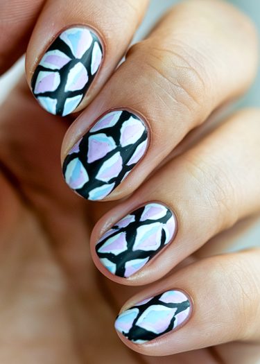 Intricate stained glass nail art in pastels with bold geometric patterns and black outlines.