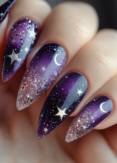 Cosmic stiletto nail art featuring a starry night design with moons and glittering stars.