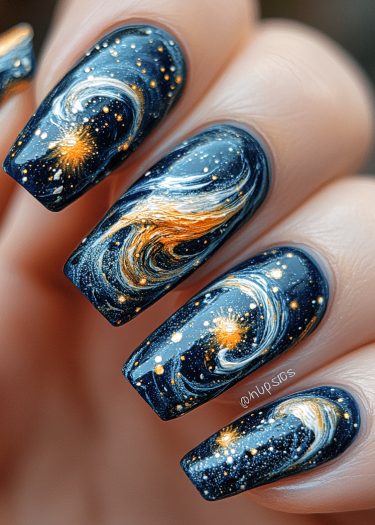 Cosmic galaxy-themed nail art with deep blue base and swirling golden and white patterns.