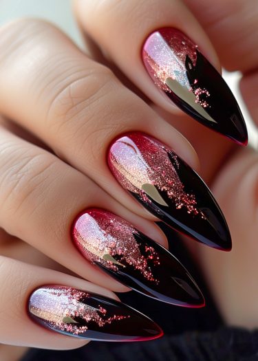 Elegant stiletto nails with black and red ombre design and glitter accents.